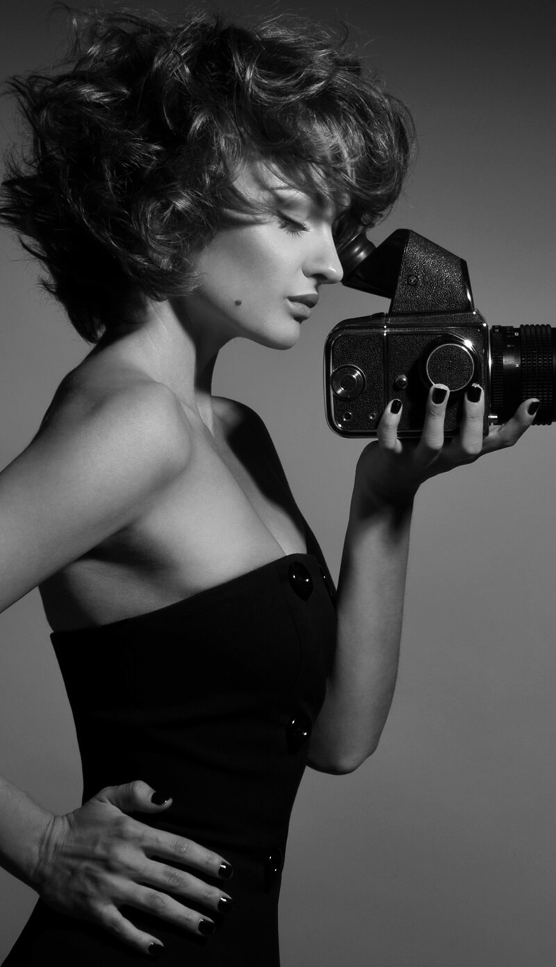 A girl in dress with a camera